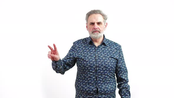 Mature Serious Man Shows Peace Sign on White Background Copy Pace Medium Shot alt