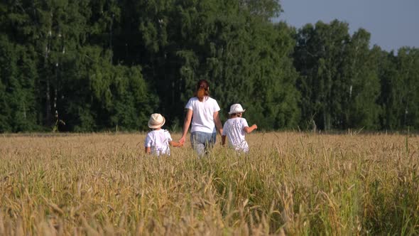 Mother with Children Walking in a Wheat Field alt