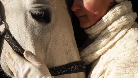 An Elderly Woman Loves Her Horse