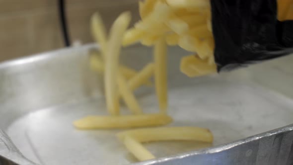 Frozen French Fries Are Put in a Metal Container for Weighing and Checking alt