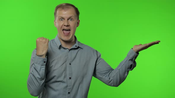 Man Showing Advertising Area. Looking Shocked, Pointing with Hands for Your Promotional Text, Logo alt