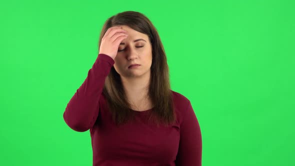 Portrait of Pretty Girl Is Tired and Sighs. Green Screen alt