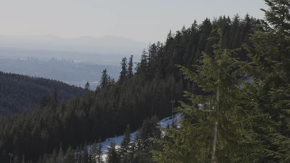 View of Top of Grouse Mountain Ski Resort with the City in the Background alt