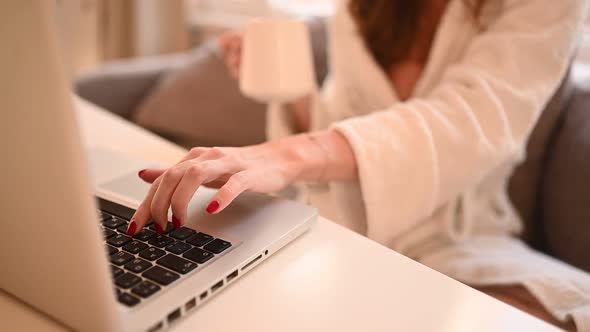 Technology Concept Close Up Young Woman Hands Working Online with Laptop Computer in White Bathrobe