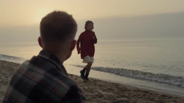 Affectionate Couple Dating on Sea Beach at Sunrise alt