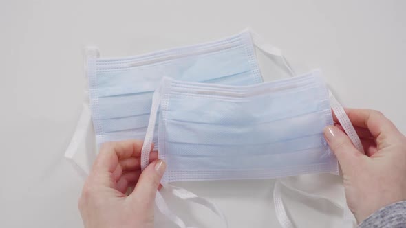 Medical blue masks for coronavirus outbreak on a white background. alt