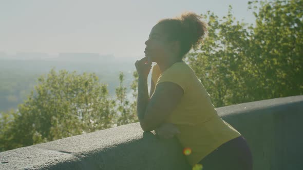 Relaxed Pretty Black Woman Enjoying Leisure at Sunrise alt