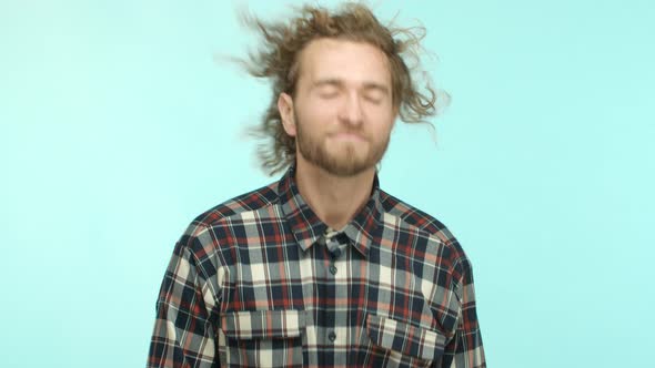 Slow Motion of Carefree Guy with Long Wavy Hair and Beard Whip Hair Back and Forth Shaking Head As