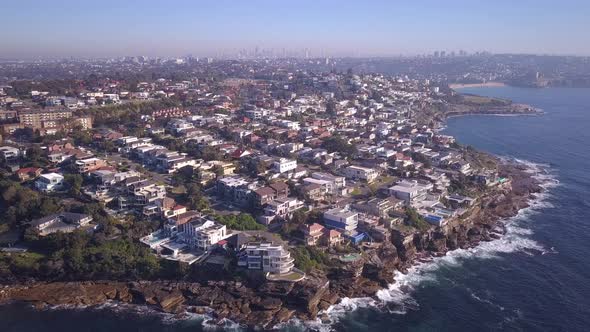 Birdeye view of Sydney eastern suburb coastal houses with city skyline, Australia. alt