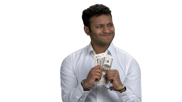 Indian Businessman Trying to Unlock His Handcuffs alt