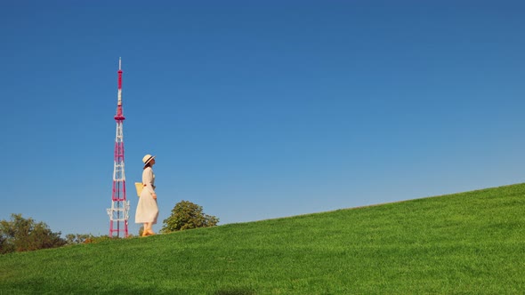 A young girl climbing to the Motherland Monument alt