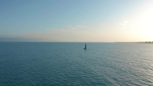 Aerial View. Sailing Yacht with White Sails in the Open Sea. alt