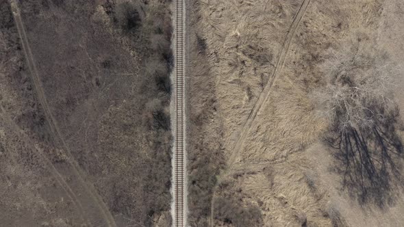 Descending on railroad in the wild nature 4K drone video alt