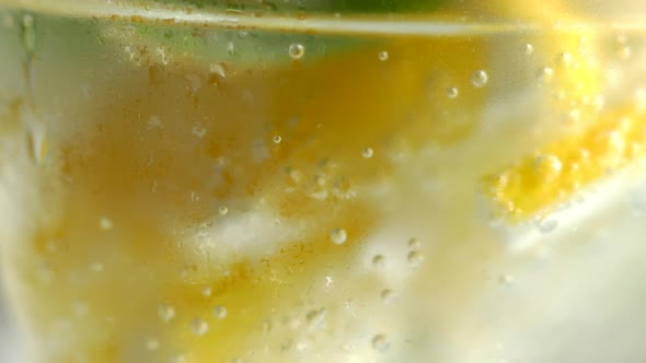 A Refreshing Soft Drink. Mojito Is Poured Into a Glass Close-up. Lemon Mint and Sparkling Water with