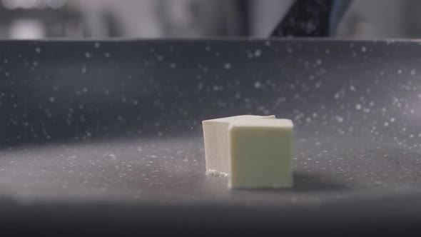Falling of the Two Pieces of Butter Cube on Frying Pan, Slow Motion alt