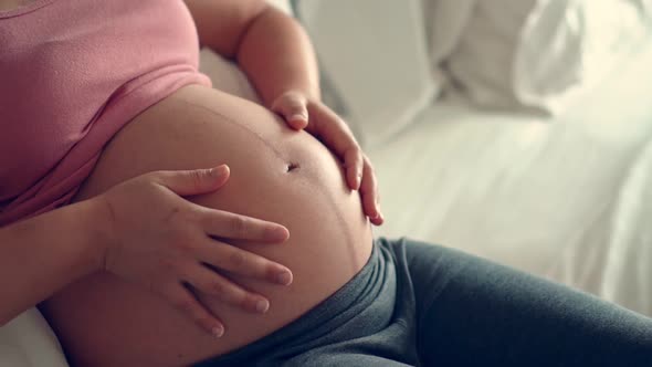 Happy Pregnant Woman and Expecting Baby at Home alt