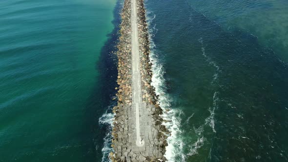 Overhead view from the end of the Gold Coast Seaway panning up toward the beach, highlighting the de alt