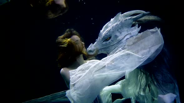 Woman is Swimming with Dragon Underwater Magic and Fairytale Concept Lady and Monster alt