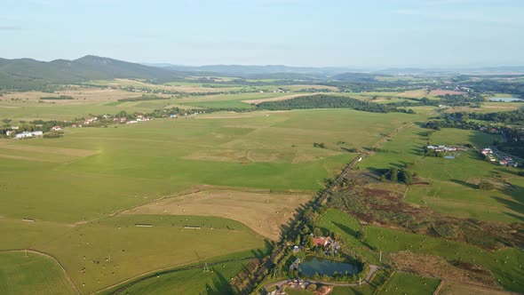 Landscape with Mountains Green Fields and Countryside Village Aerial View alt