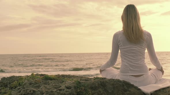 practice of yoga on the beach: woman having meditation moments, spiritual time alt