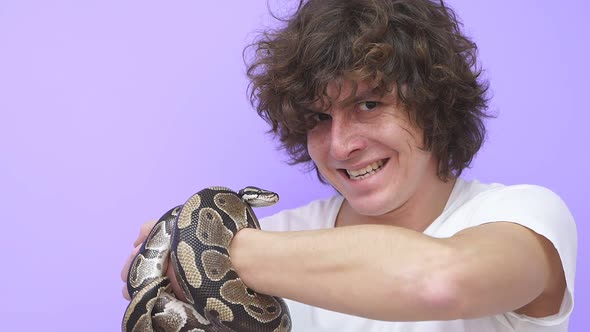 A Snake Crawls on a Man's Hand