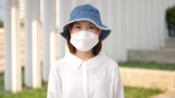 Asian woman wearing a mask.