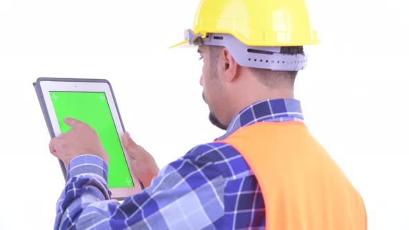 Closeup Rear View of Bearded Persian Man Construction Worker Using Digital Tablet alt
