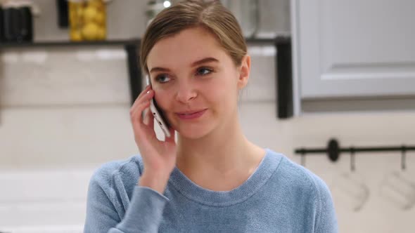 Portrait of Young Woman Talking on Mobile Phone at Home alt