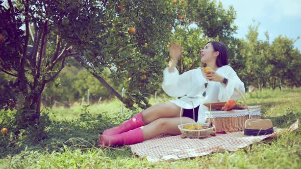 attractive female wearing casual dress sit relax picnic in orange fresh garde alt