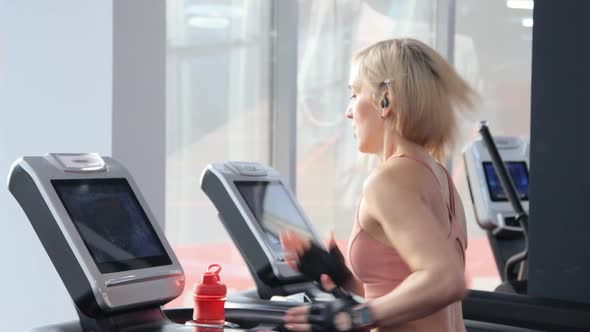 Young woman training on treadmill