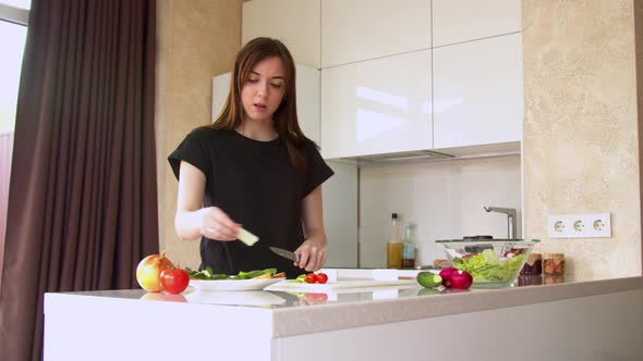 Woman Preparing Sandwich in Kitchen