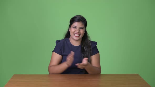 Young Overweight Beautiful Indian Businesswoman Against Green Background alt