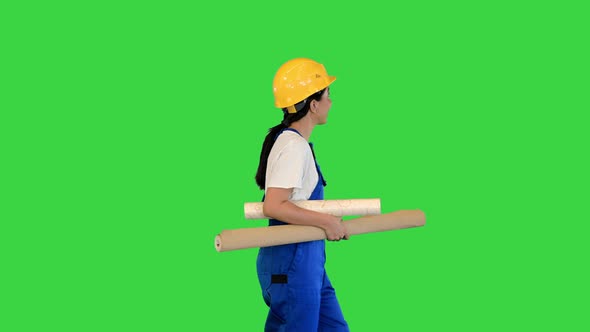 Woman Holding Wallpaper Rolls Walking on a Green Screen Chroma Key