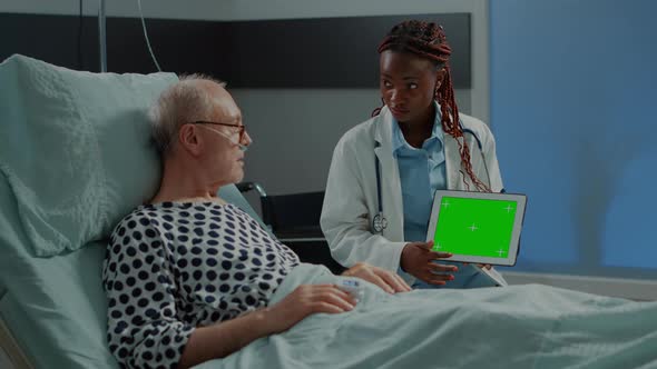 African American Medic Showing Greenscreen on Tablet alt