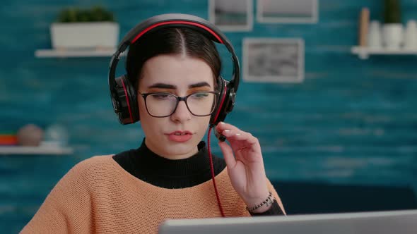 Female Person Wearing Headset at Online Videoconference Call alt