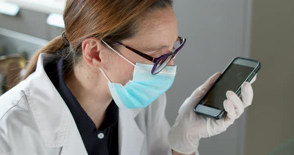 Female doctor using smartphone