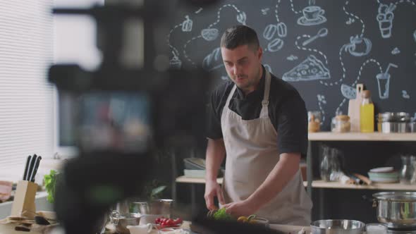 Male Vlogger Recording Video Lesson in Kitchen alt