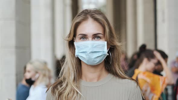 Woman in Mask Looking at Camera Closeup People Coronavirus Covid-19. Portrait. alt