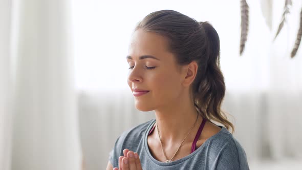 Woman Meditating at Yoga Studio alt