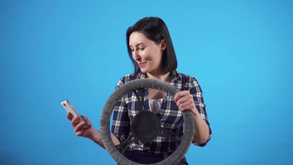 Portrait Istracted Female Driver Uses Smartphone at the Wheel and Gets Distracted From Driving alt