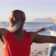 Senior african american couple practising yoga at the beach