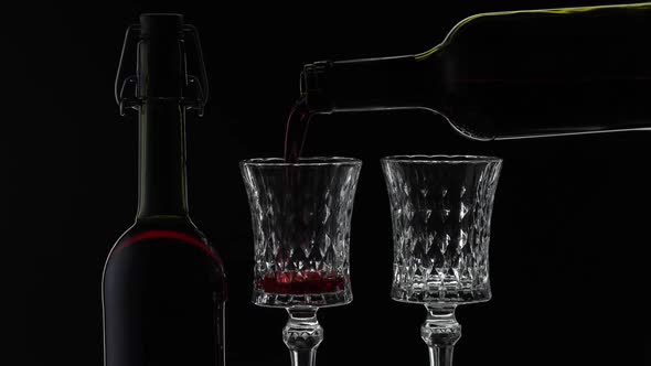 Rose Wine, Red Wine Pour in Two Wine Glasses Over Black Background, Silhouette alt