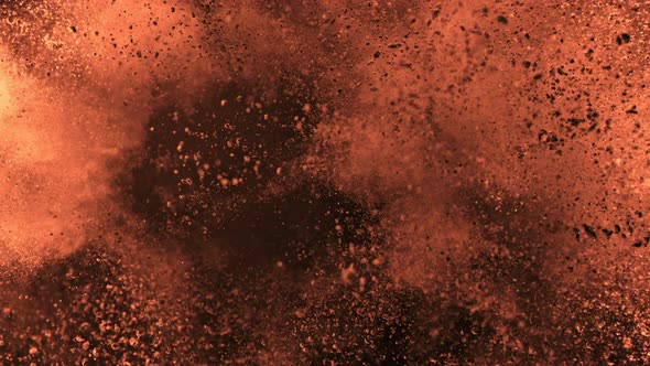 Super Slow Motion Shot of Brown Powder Explosion Isolated on Black Background at 1000Fps alt