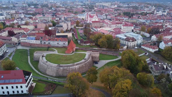 Slow backing aerial over parks, Castle Hill and old town of Vilnius, day alt