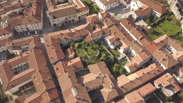 Top down aerial view of a small historic town Venzone in Northern Italy with red tiled roofs alt