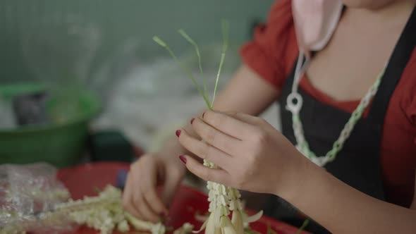 Thai Lady Assembling Handmade Crown Flowers For Traditional Thai Jasmine Garland Inside The Flower alt