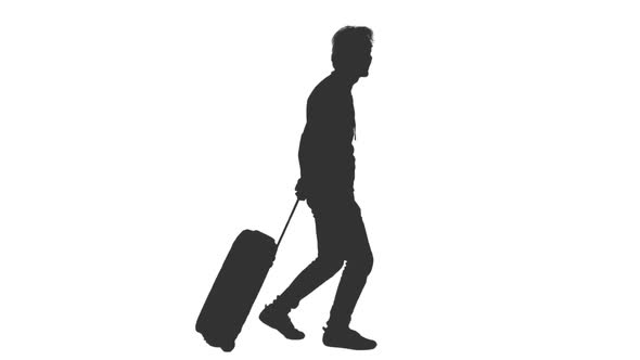 Silhouette of Man Tourist Goes With Luggage