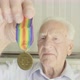 Senior man looking at an old medal - VideoHive Item for Sale