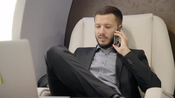 Portait of Investor Expert Analyst Businessman Talking on Phone in Private Jet