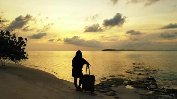 Girl happy and smiling on paradise island beach vacation by shallow lagoon and white sand background alt